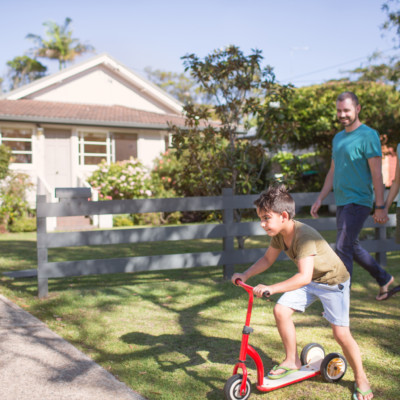 Australian parents and child on a scooter outdoors