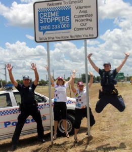 Emerald Volunteer Area Committee Jump for Joy under Road Sign